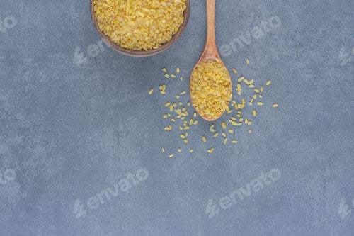 Preview: A spoonful of rice and a bowl of rice , on the marble background