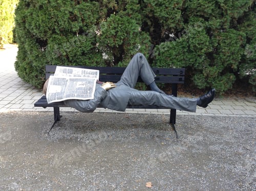 Preview: Sculpture Reading Newspaper Lying on Park Bench