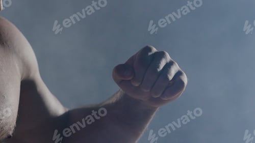 Preview: The man in boxing gloves. Young Boxer fighter over black background. Boxing man ready to fight