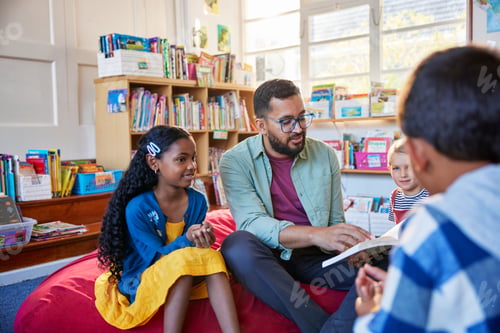 Preview: Teacher reading a fairy tale to pupil at school library
