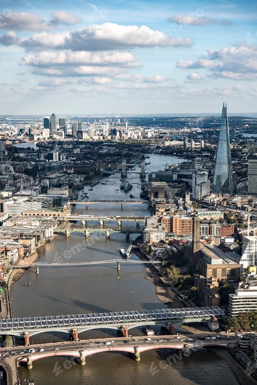 Preview: Aerial view of a bustling cityscape with iconic skyscrapers and bridges over a winding river