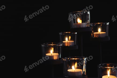 Preview: Burning candles on dark background. Funeral symbol