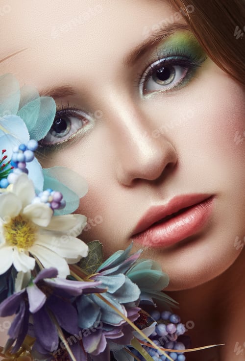Preview: Woman with a wreath of blue flowers on her head. Beautiful makeup and flowers, natural clean skin