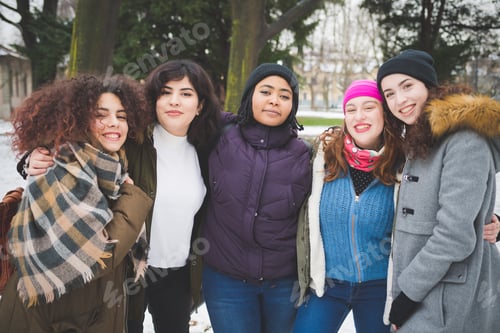Preview: portrait of young women standing in park and hugging
