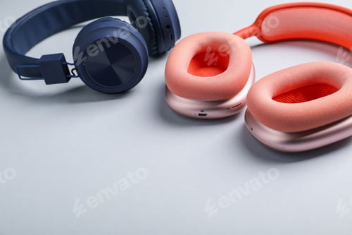 Preview: Different stylish headphones on light grey background, closeup. Space for text