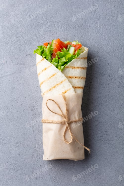 Preview: Wrap Sandwich, Roll with Fish Salmon and Vegetables. Grey Background. Top View.