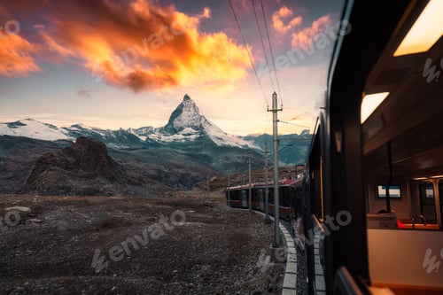 Preview: View from train with sunrise over Matterhorn mountain during ride up to Gornergrat station