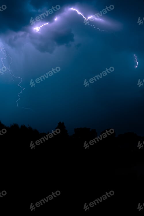 Preview: Silhouette of trees under thunder and lightning