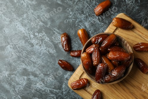 Preview: Board with bowl of dried dates on black smokey background