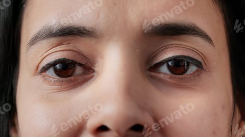 Preview: Macro shot portrait of authentic indian woman blinking in front of camera