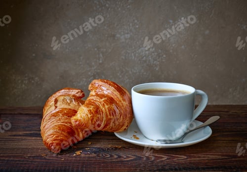 Preview: cup of coffee and croissants