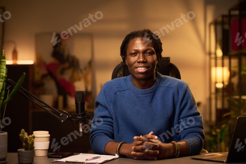 Preview: Portrait of Smiling African American Man in Cozy Studio Setting