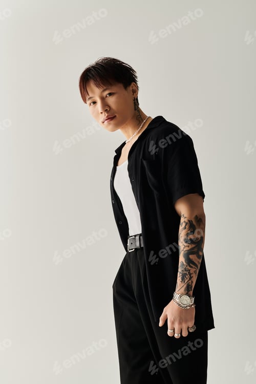 Preview: Stylish young man showcases modern fashion in minimalist indoor setting