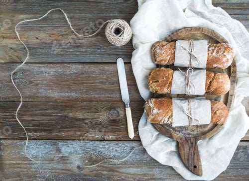 Preview: Freshly baked rustic village bread (baguettes) wrapped in paper
