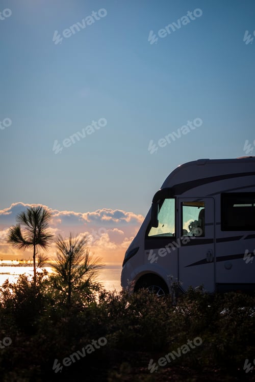 Preview: Summer travel vehicle vacation lifestyle. Modern camper van parked against a beautiful sunset
