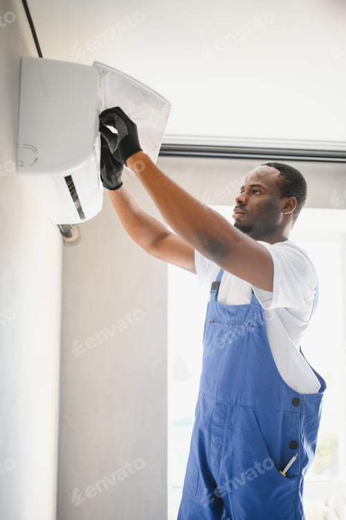 Preview: Happy Young African Male Technician Repairing Air Conditioner