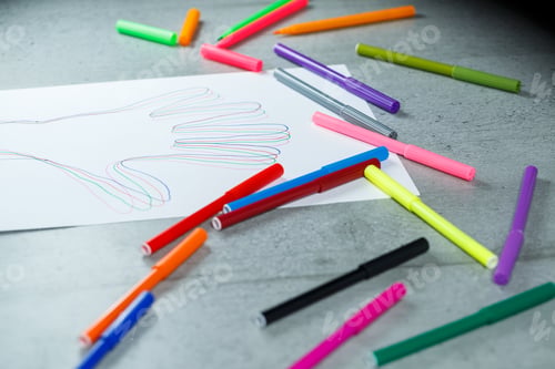 Preview: many multi-colored markers for drawing with drawings on white paper