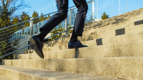 Preview: Businessman in black classic shoes and trousers runs going up the stairs. businessman in nice shoes