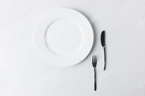 Preview: Top view of plate with fork and knife, table appointments conception
