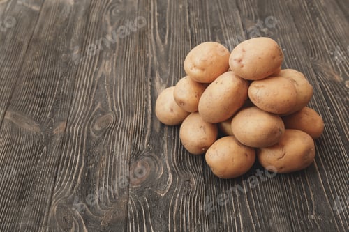 Preview: Pile of Uncooked Potatoes on a Rustic Table