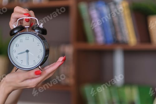 Preview: woman with red nails shows time on alarms, time management for women