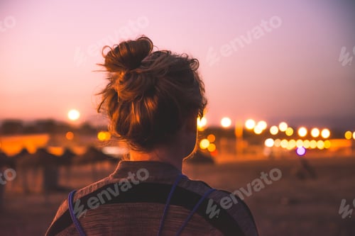 Preview: Woman at beach at night sunset