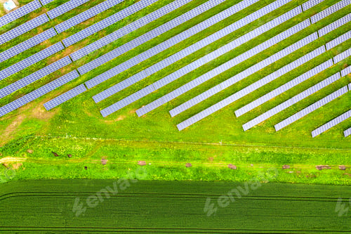 Preview: Aerial view of solar power plant on green field. Electric panels
