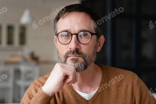 Preview: Front view portrait of a confident thoughtful pensive Caucasian middle-aged mature man