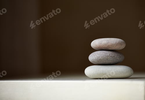 Preview: Find your balance. Three stones balanced on top of each other in natural light.