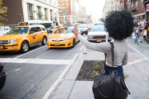 Preview: African American woman hailing a taxi cab in New York city