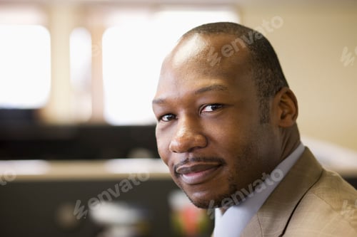 Preview: A black businessman at his desk in his office.