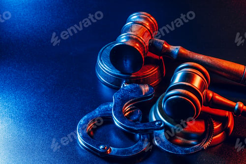 Preview: Judge gavel and handcuffs on dark black background