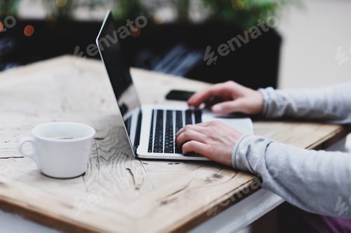 Preview: Creative male with internet technology and hands typing on laptop keyboard in natural light at cafe