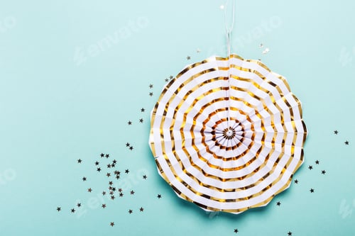 Preview: Golden striped decoration on turquoise background. Party concept