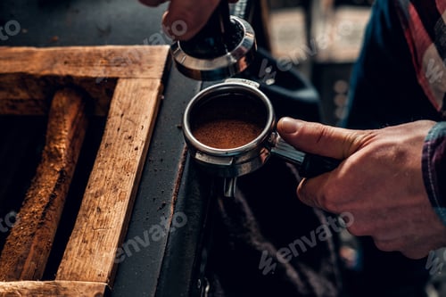 Preview: Close up image of a man making coffee.