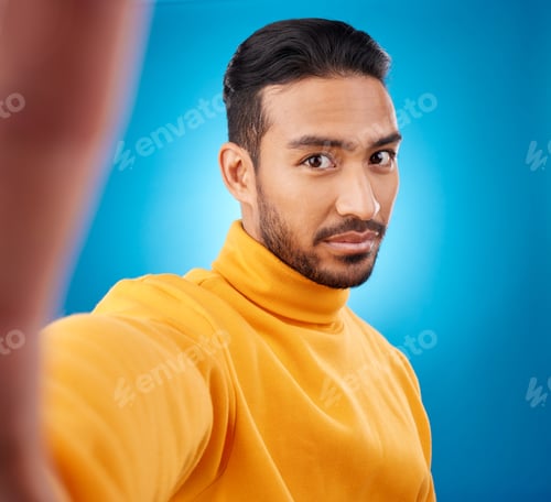 Preview: Selfie, face and portrait of a young man in studio with hand, style and fashion clothes. Serious ma