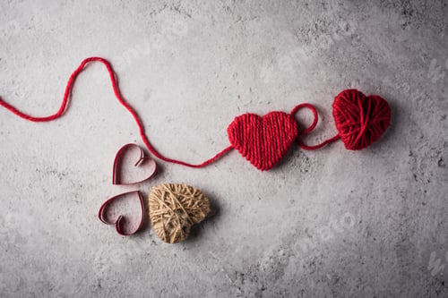 Preview: Red yarn heart shaped on the wall background