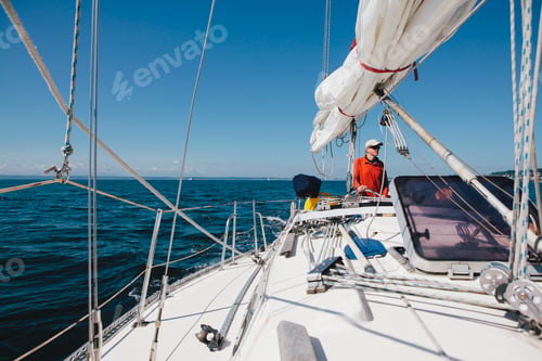 Preview: Middle aged man steering sailboat on Puget Sound, Washington, USA
