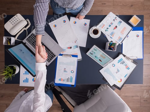 Preview: Top view of business women shaking hands in corporate office