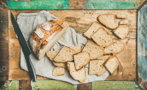 Preview: Flat-lay of sourdough wheat bread cut in slices in tray