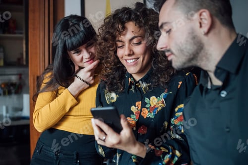 Preview: Friends using smartphone at home