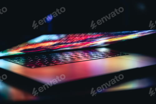 Preview: Close up of laptop keyboard colorful neon illumination, backlit keyboard.