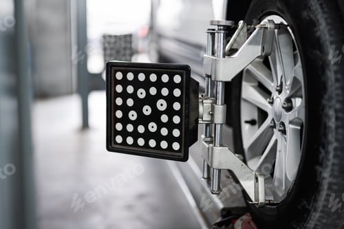 Preview: Car wheel alignment with specialized equipment in auto repair shop