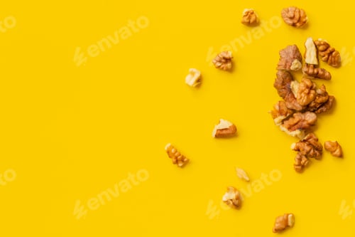 Preview: peeled walnut on yellow background isolated text design