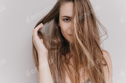 Preview: Close-up portrait of dark-eyed girl isolated on white background. Indoor shot of winsome european l