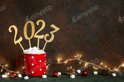 Preview: Christmas or New Year 2023 concept. Red mug with hot chocolate and marshmallows and golden numbers