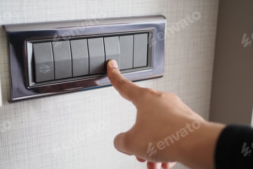 Preview: A finger turning on lighting switch .