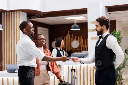 Preview: Bellboy accepting cash from hotel guest