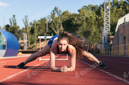 Preview: A female athlete warming up before running.