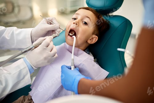 Preview: Little boy having his teeth examined at dentist's office.